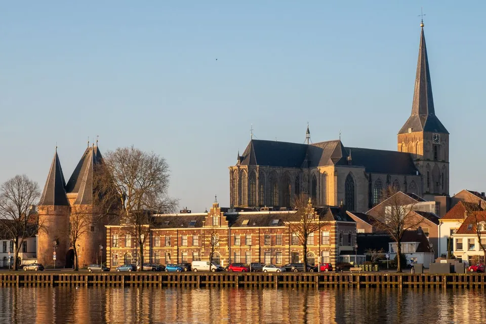 Stadsfront van Kampen aan de IJssel met een stadspoort en een grote kerk